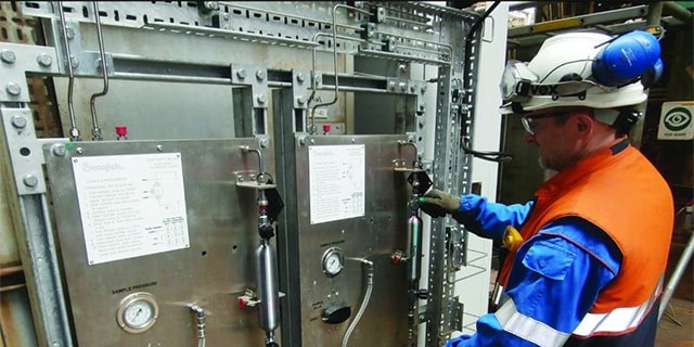 Engineer examining a sampling system analyzer