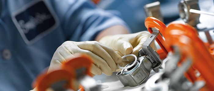 Manufacturing associate assembling a ball valve