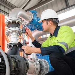Industrial inspector verifying fluid system are ready for startup 