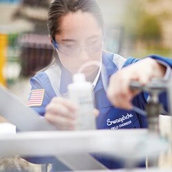 Industrial inspector checking for fluid system leaks