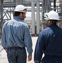 Engineers surveying a downstream operation
